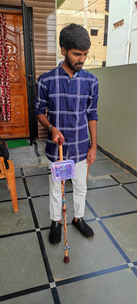 Uday with the smart blind stick he built
